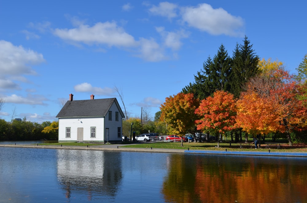 white and gray house near body of water during daytime