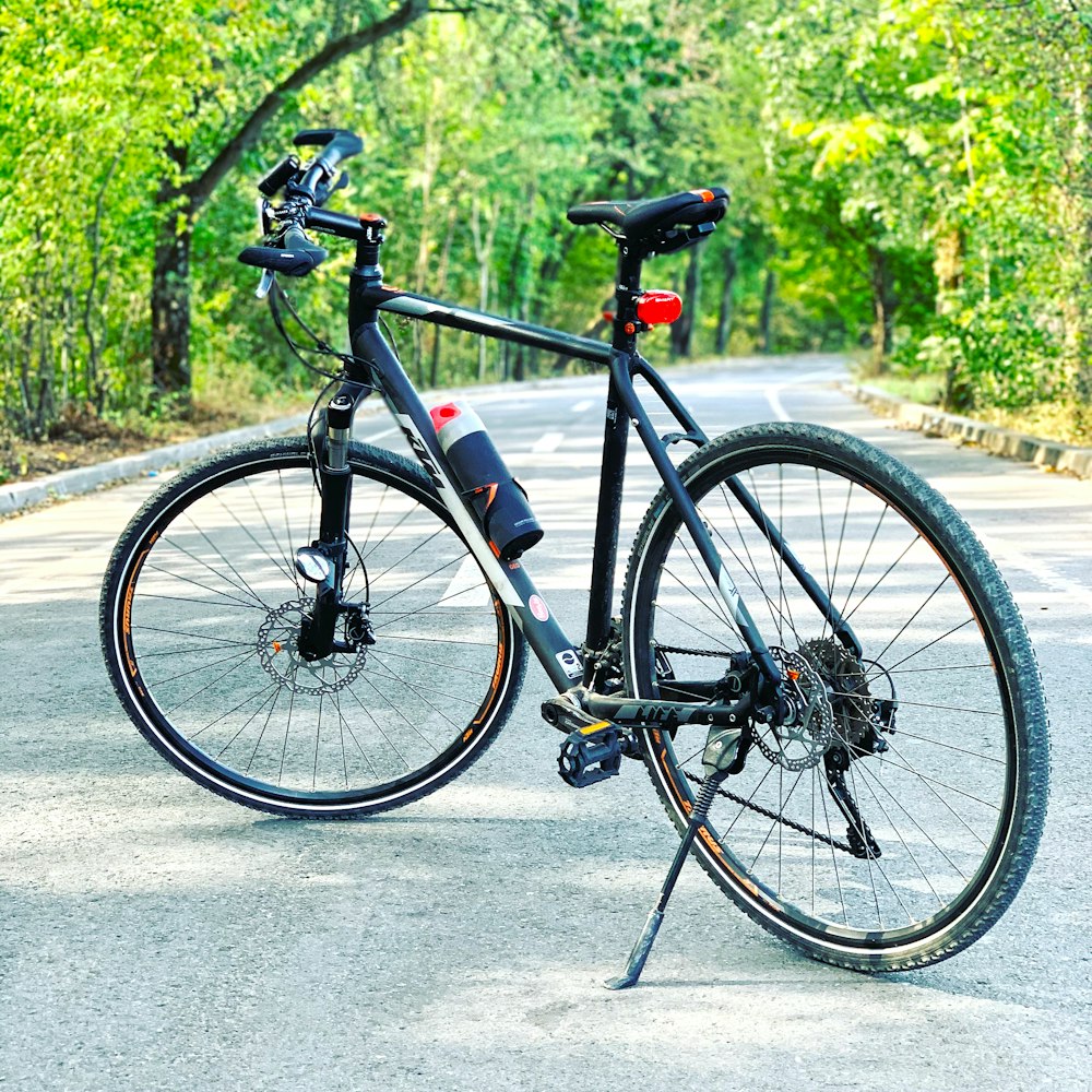 black and white road bike on gray concrete road