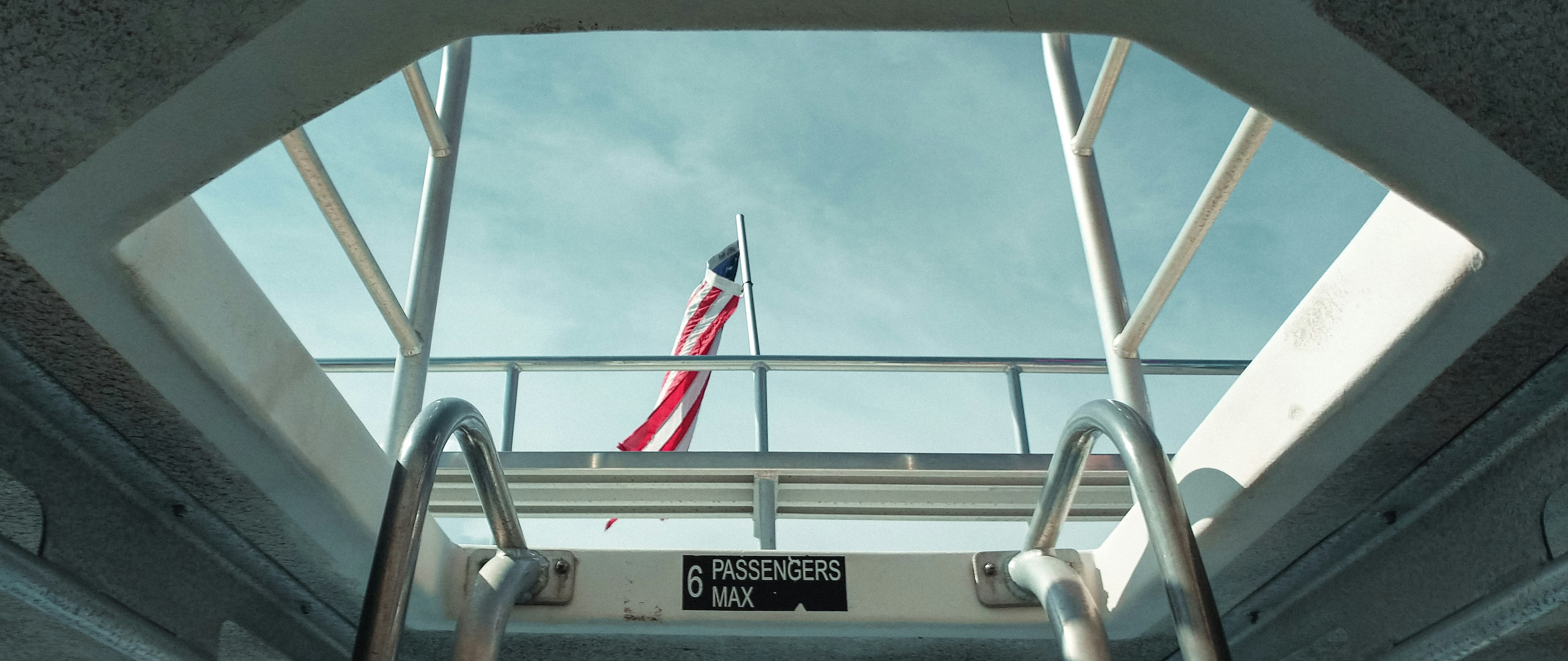 View of American Flag at the top of a boat.
