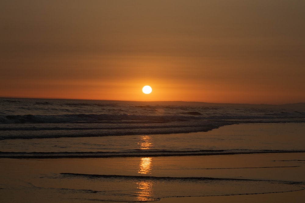 body of water during sunset