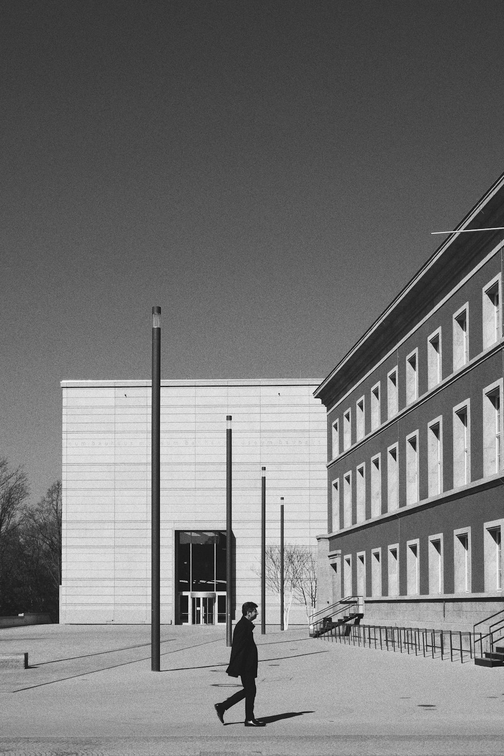 grayscale photo of building near trees