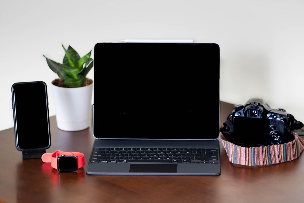 black and gray laptop computer beside red and black computer mouse