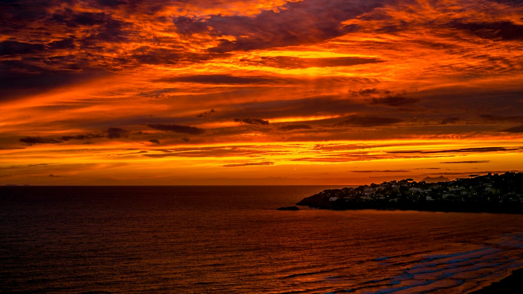 body of water during sunset