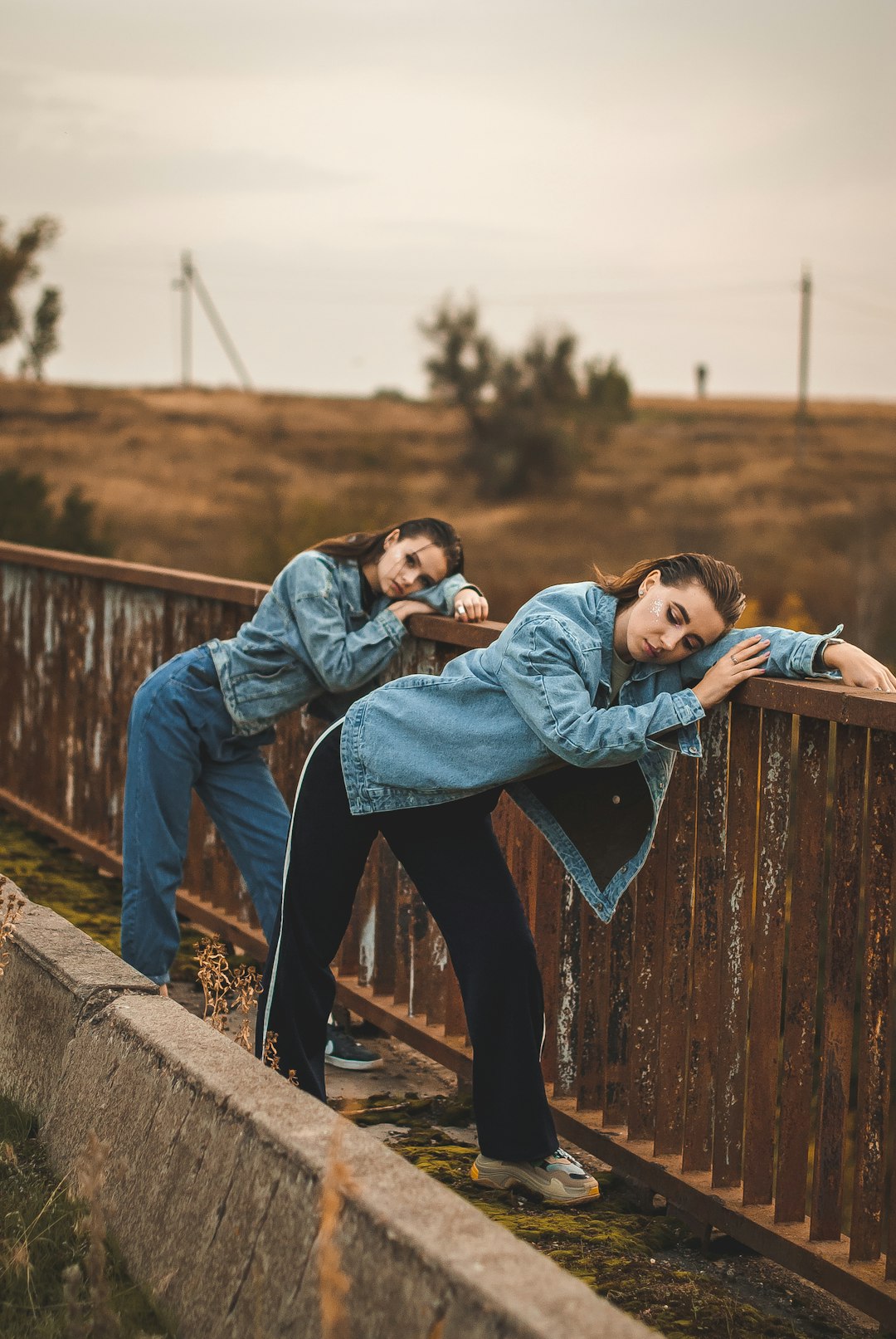 man in blue denim jacket carrying girl in blue jacket