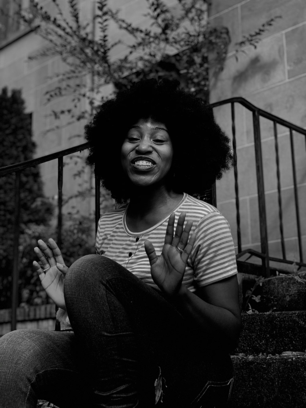 woman in black and white striped shirt sitting on concrete stairs