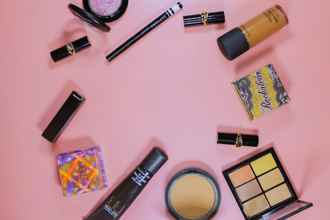 black and silver tube bottle, Flat lay featuring makeup and beauty items of a female traveler.