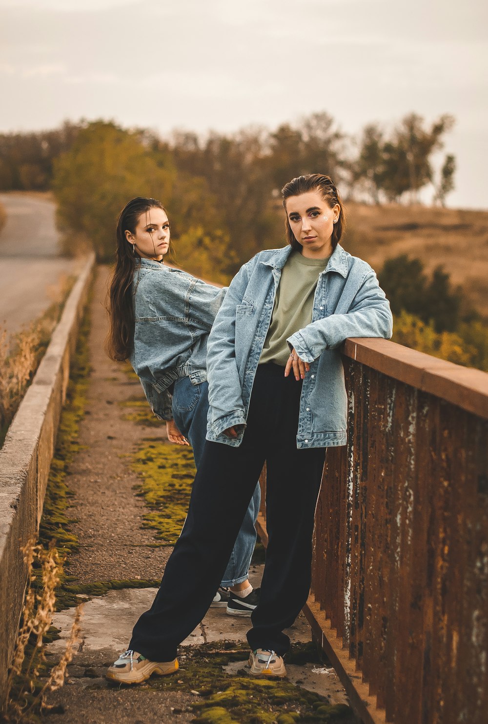 woman in gray jacket standing beside woman in gray coat