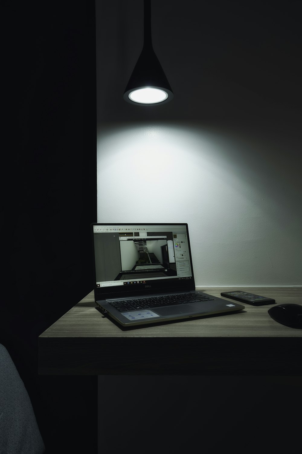 black laptop computer on brown wooden table