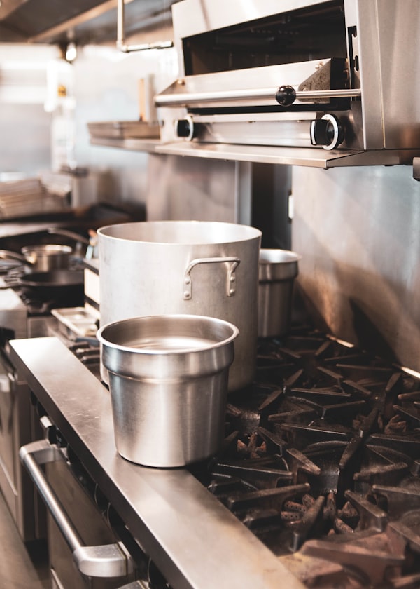 Commercial stock pots on a professional restaurant stove
