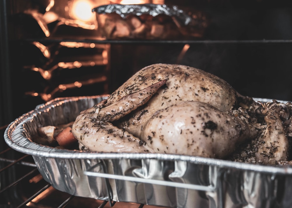 brown and black grilled chicken on stainless steel tray