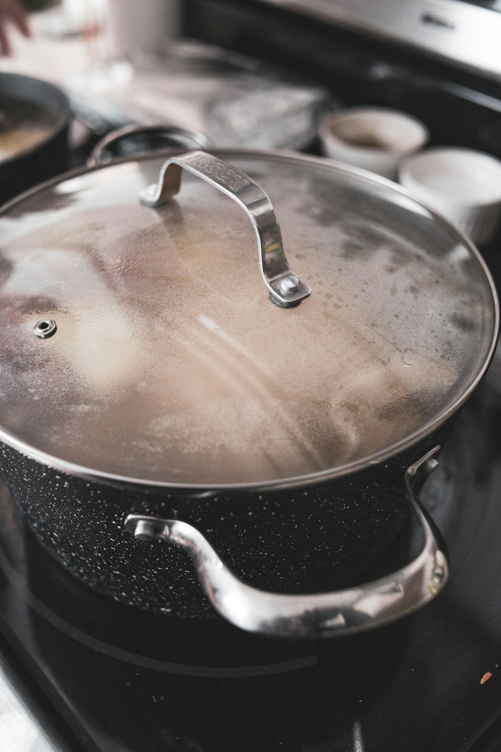 stainless steel cooking pot with brown liquid