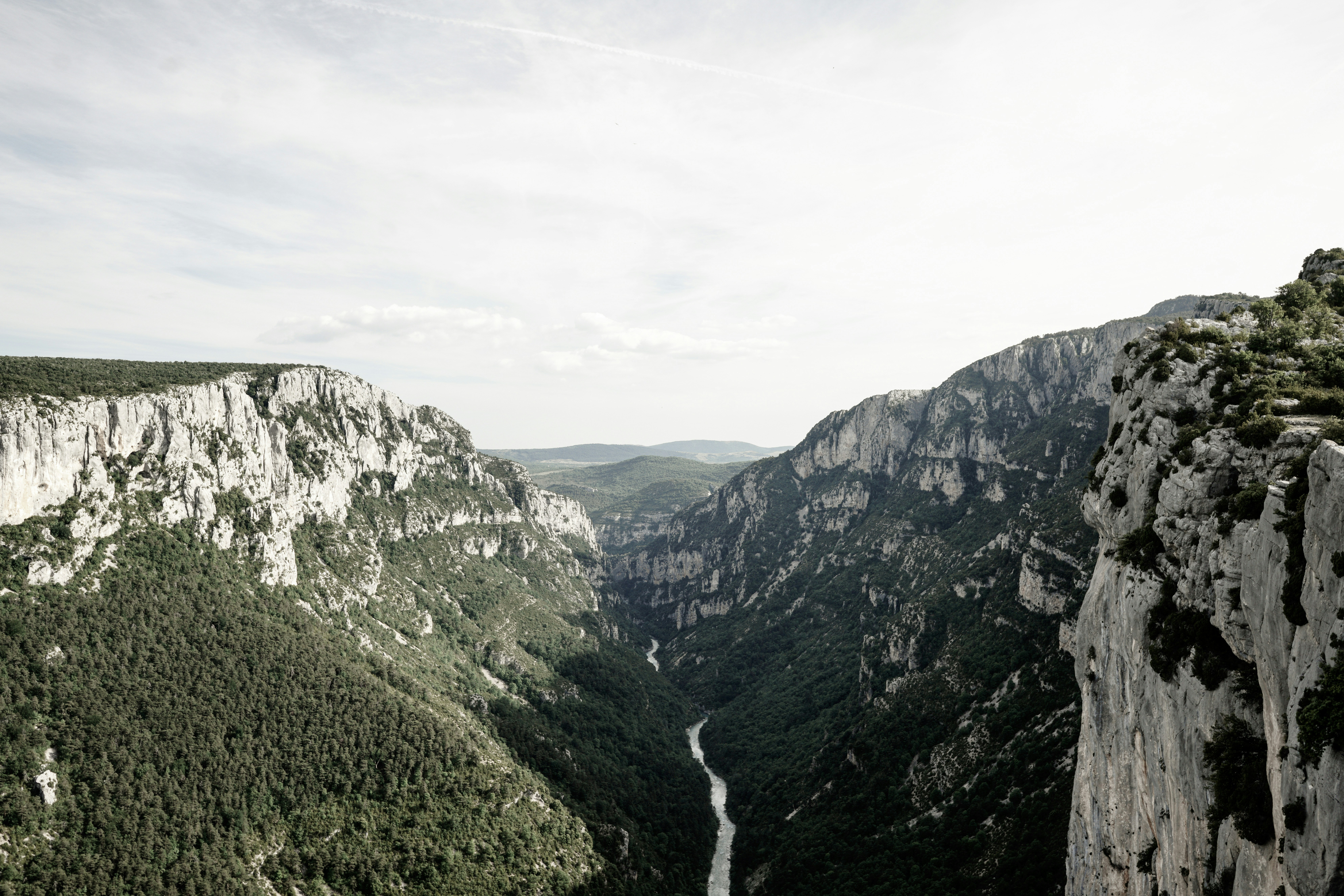 river between mountains under white sky during daytime, 