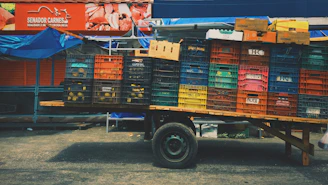 A sturdy platform cart loaded with boxes, ready for delivery on a sunny Moroccan street.