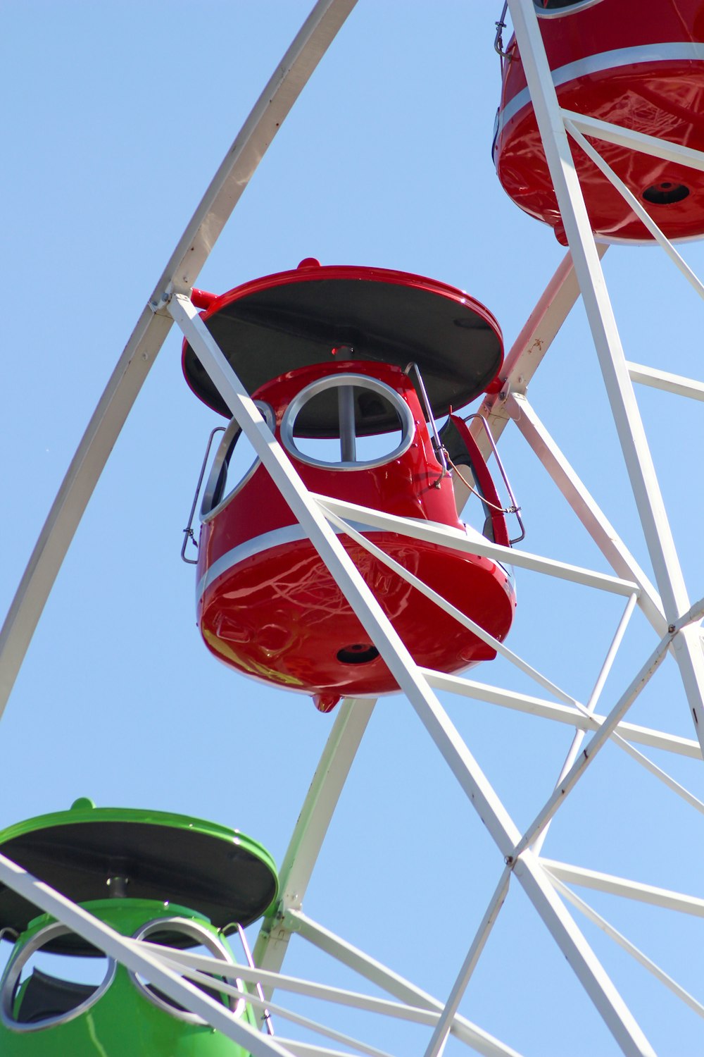 red and white ferris wheel under blue sky during daytime