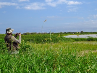 man and woman kissing on green grass field during daytime