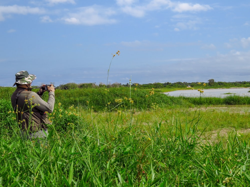 man and woman kissing on green grass field during daytime