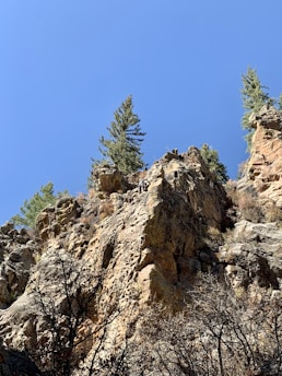 A climber scaling a rocky cliff.