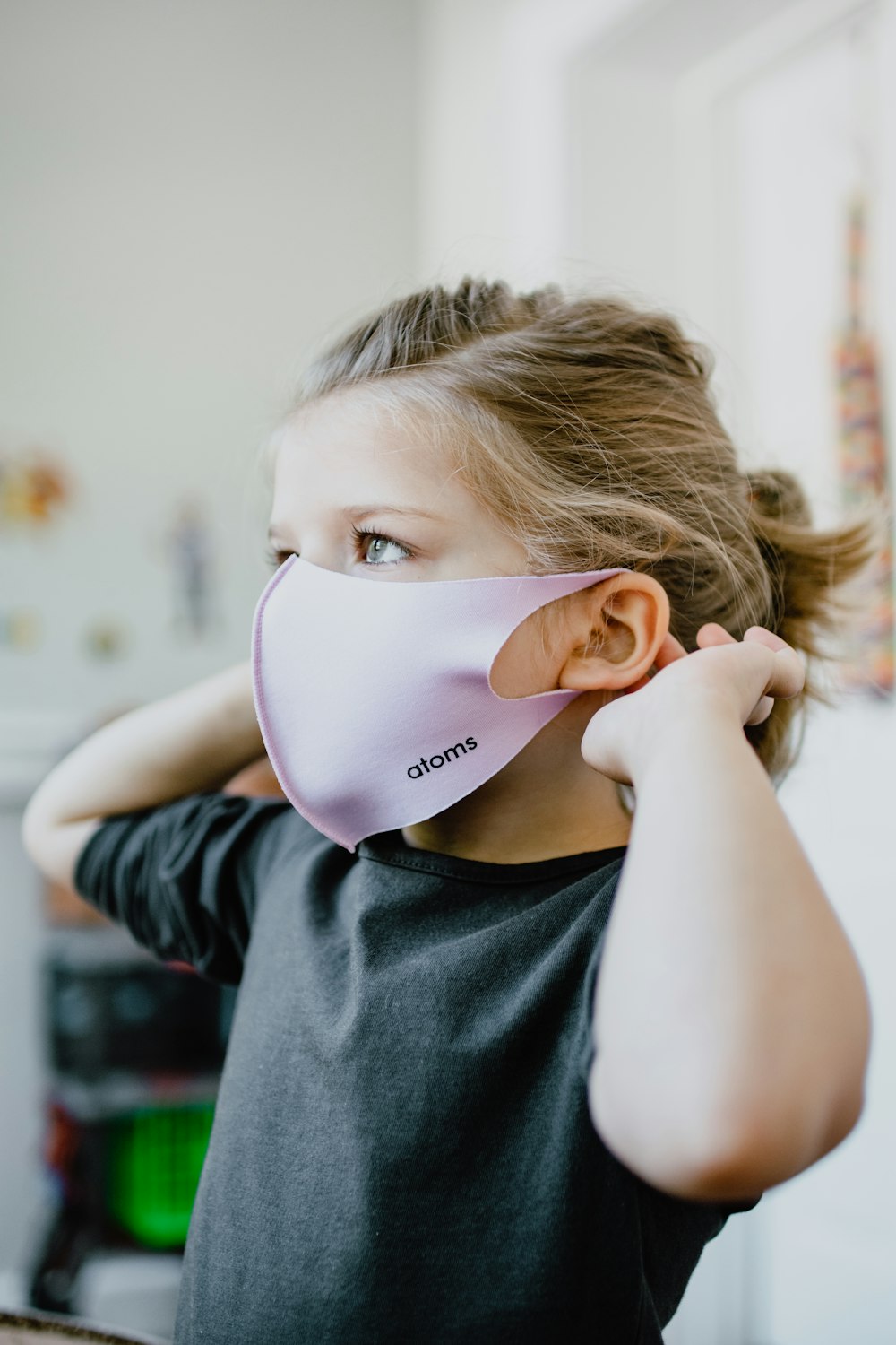 girl in gray crew neck shirt wearing white face mask