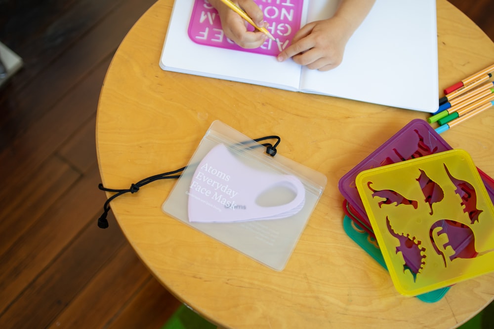 Bolsa de papel blanca y morada sobre mesa redonda amarilla