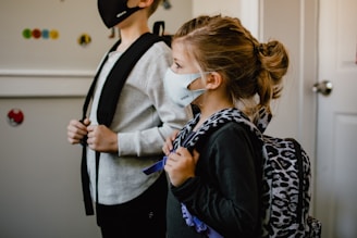woman in black long sleeve shirt holding white face mask