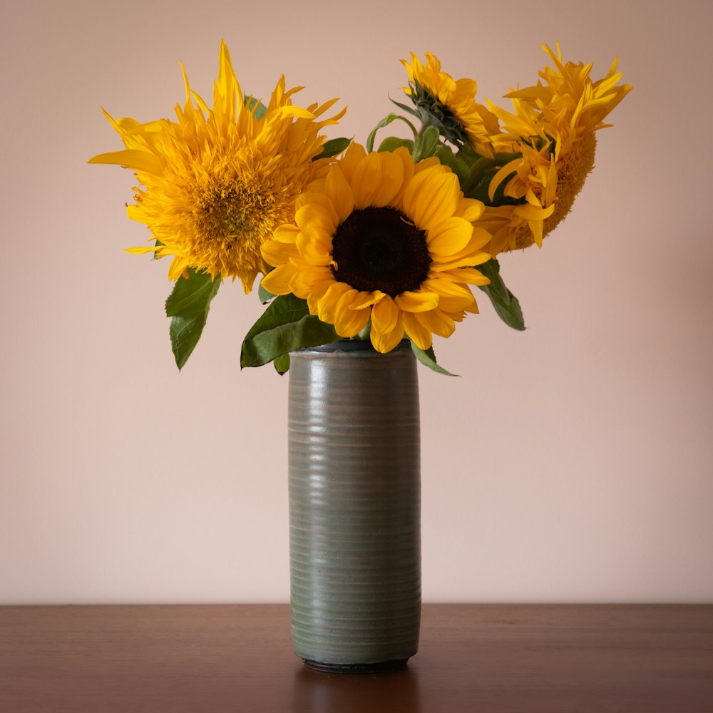 yellow sunflower in blue vase