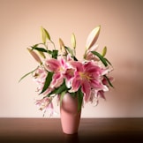 pink and white flowers on white ceramic vase
