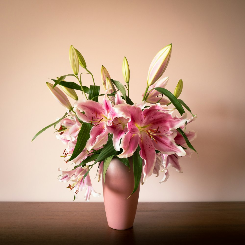 pink and white flowers on white ceramic vase