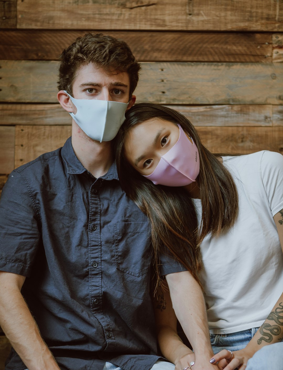 woman in white shirt and blue denim button up jacket with white face mask