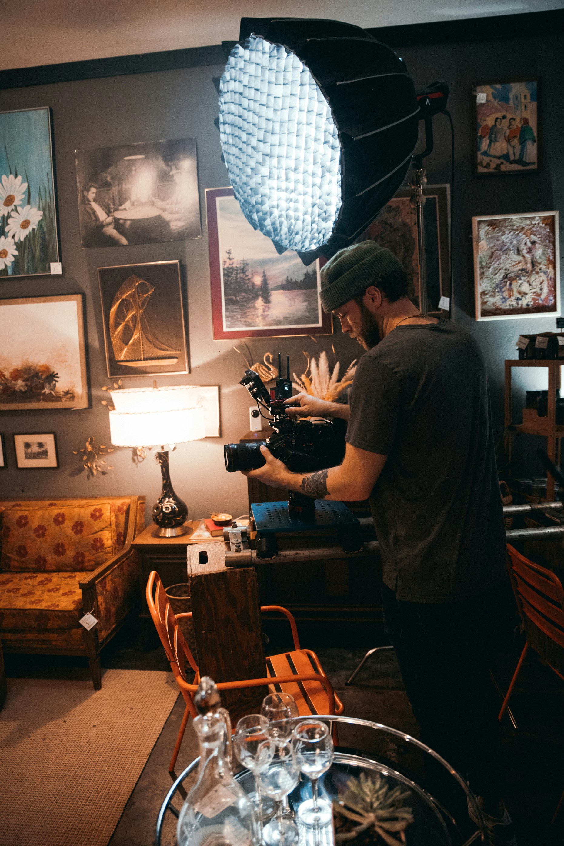 man in gray t-shirt standing near brown wooden table