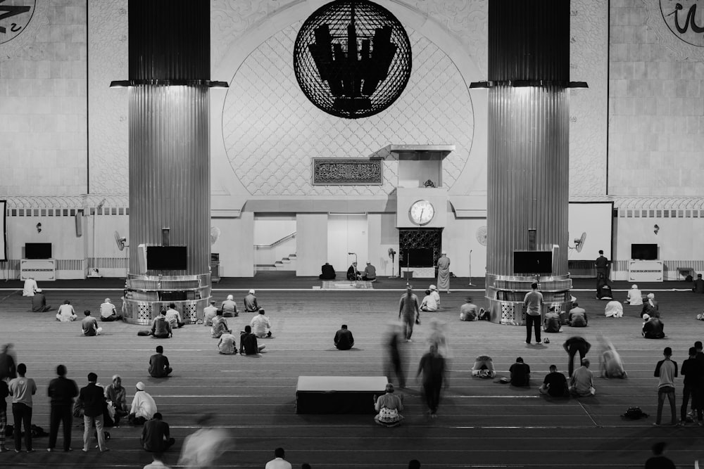 grayscale photo of people in a building