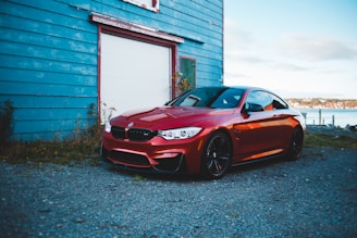 A sleek red sports car parked in a scenic location.