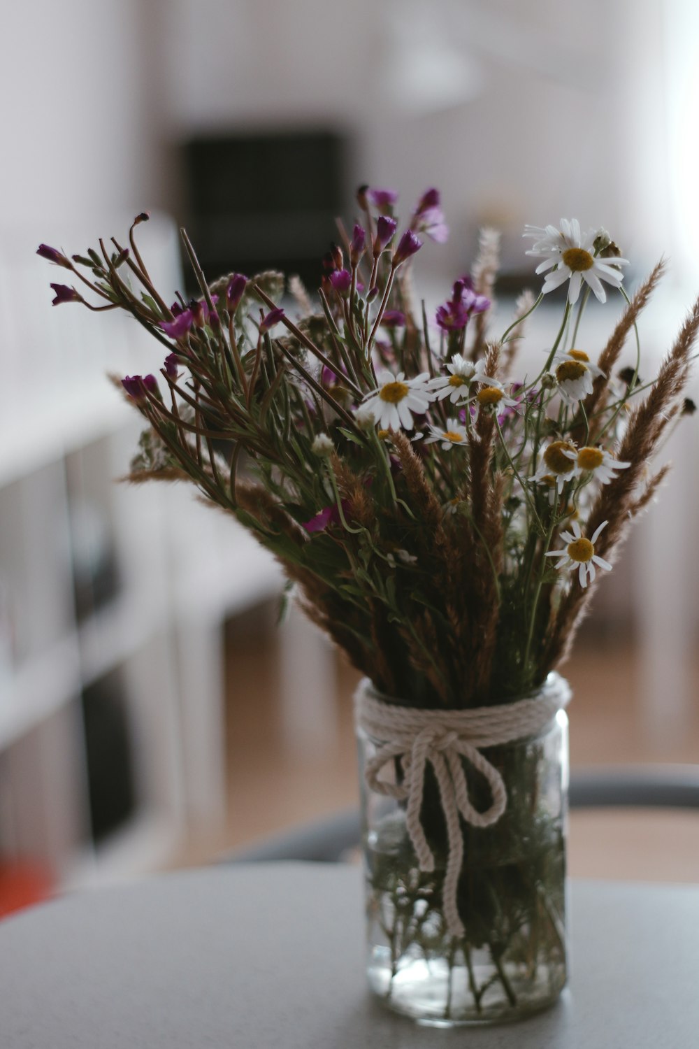 pink and white flowers in clear glass vase