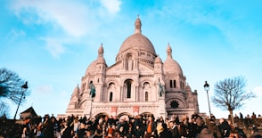 people standing near brown concrete building during daytime