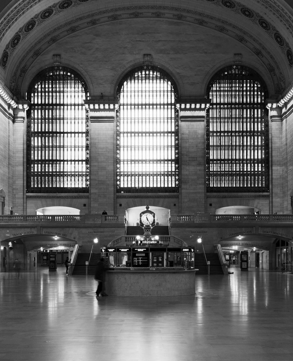 grayscale photo of people in building