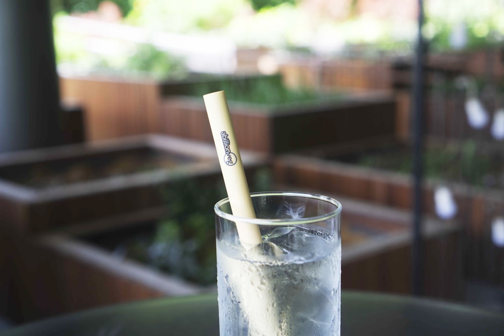 clear drinking glass with white straw