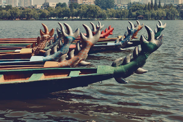 A vibrant dragon boat team paddling fiercely through the shimmering water during a race.