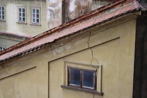 Detailed shot of a building facade with visible cracks, captured during a physical inspection.