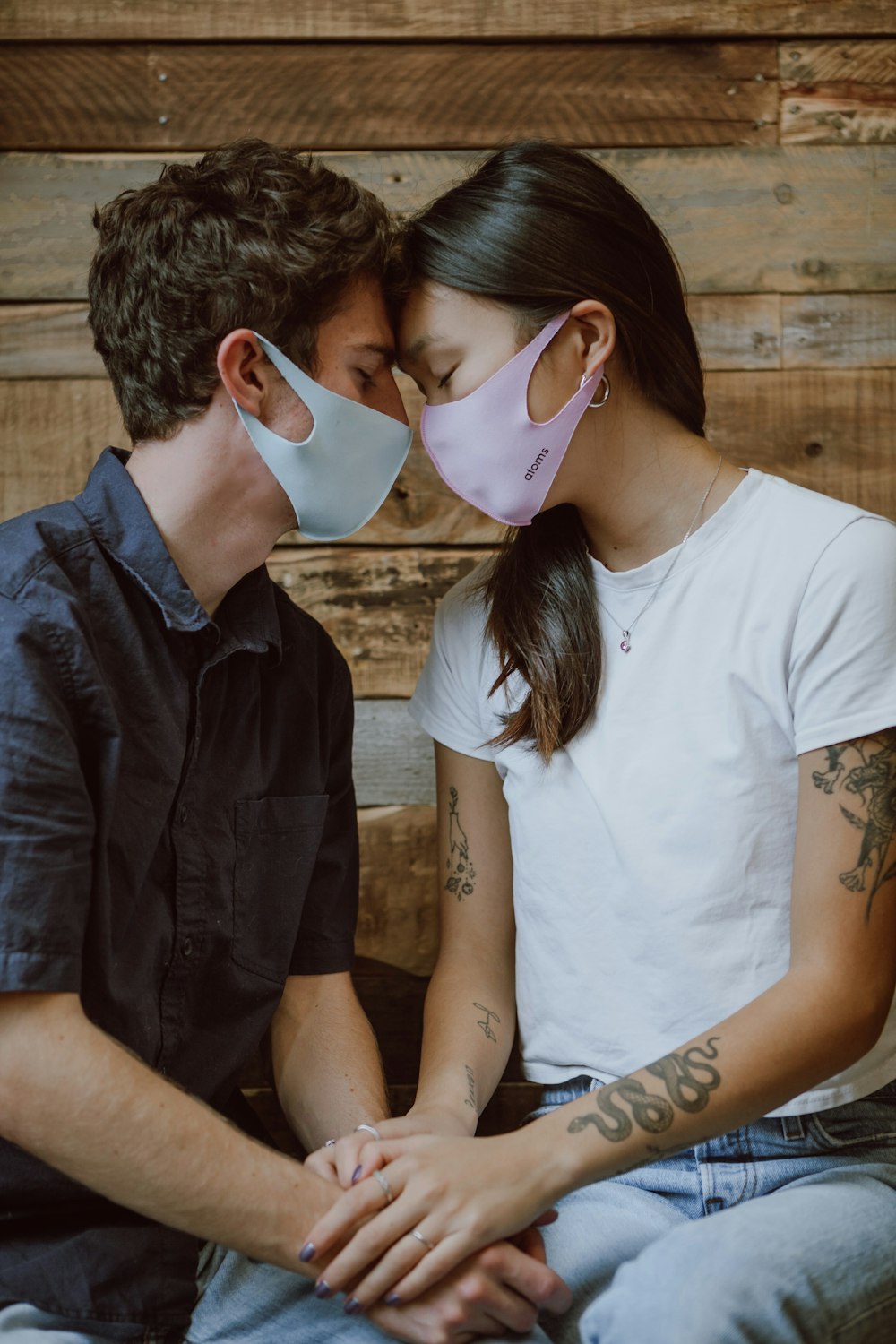 man in blue button up shirt kissing woman in white shirt