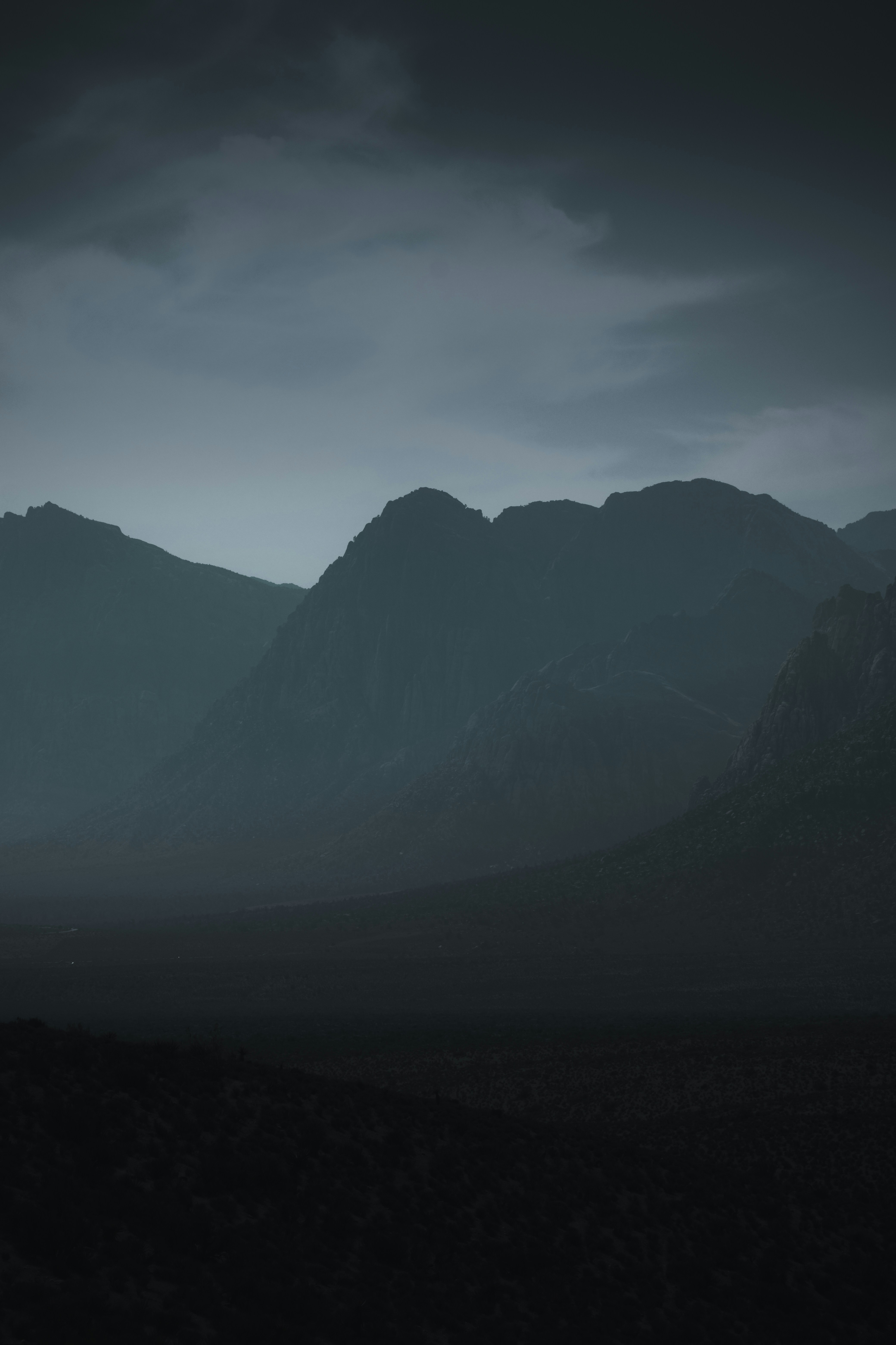 black mountains under white clouds during daytime