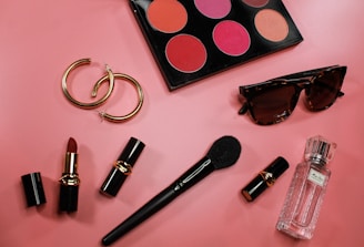 black and pink lipstick on pink surface