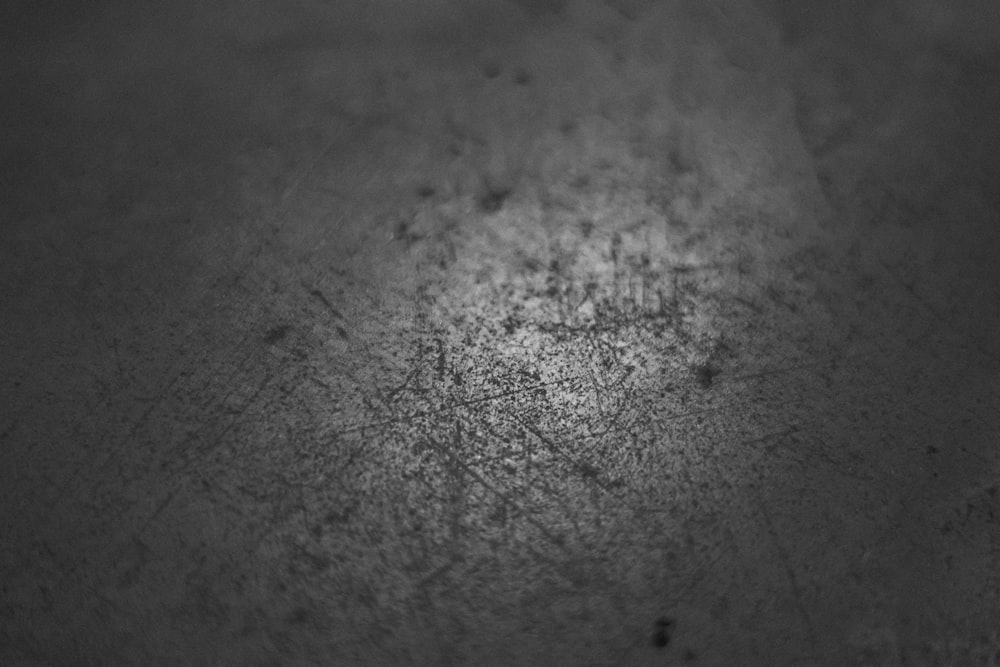 grayscale photo of water droplets on ground