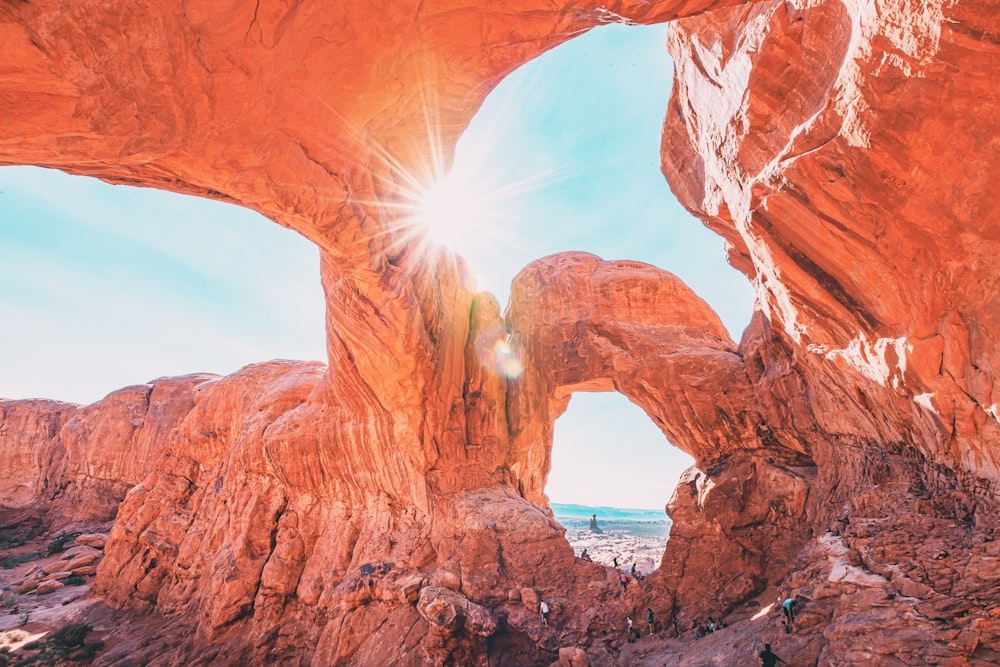 brown rock formation near body of water during daytime