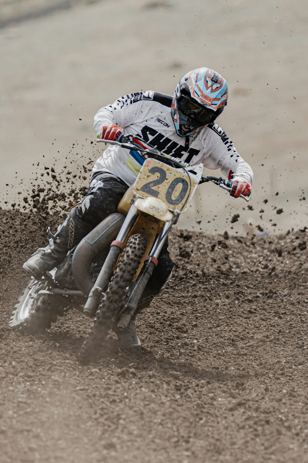 man in black and white racing suit riding on motocross dirt bike