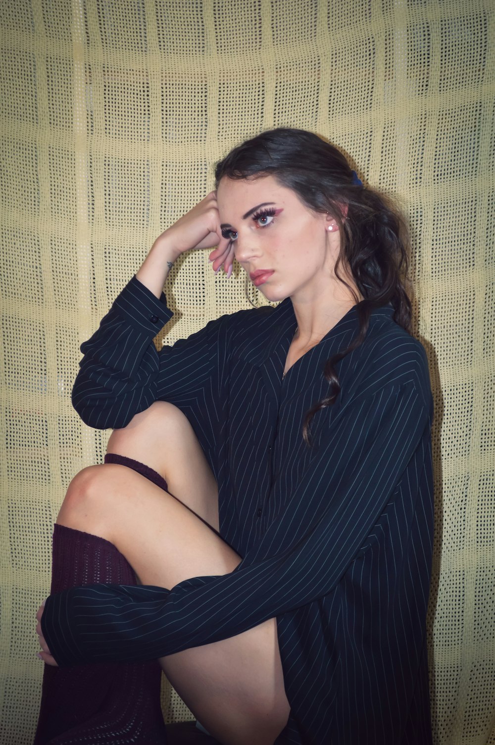 woman in black dress sitting on brown sofa
