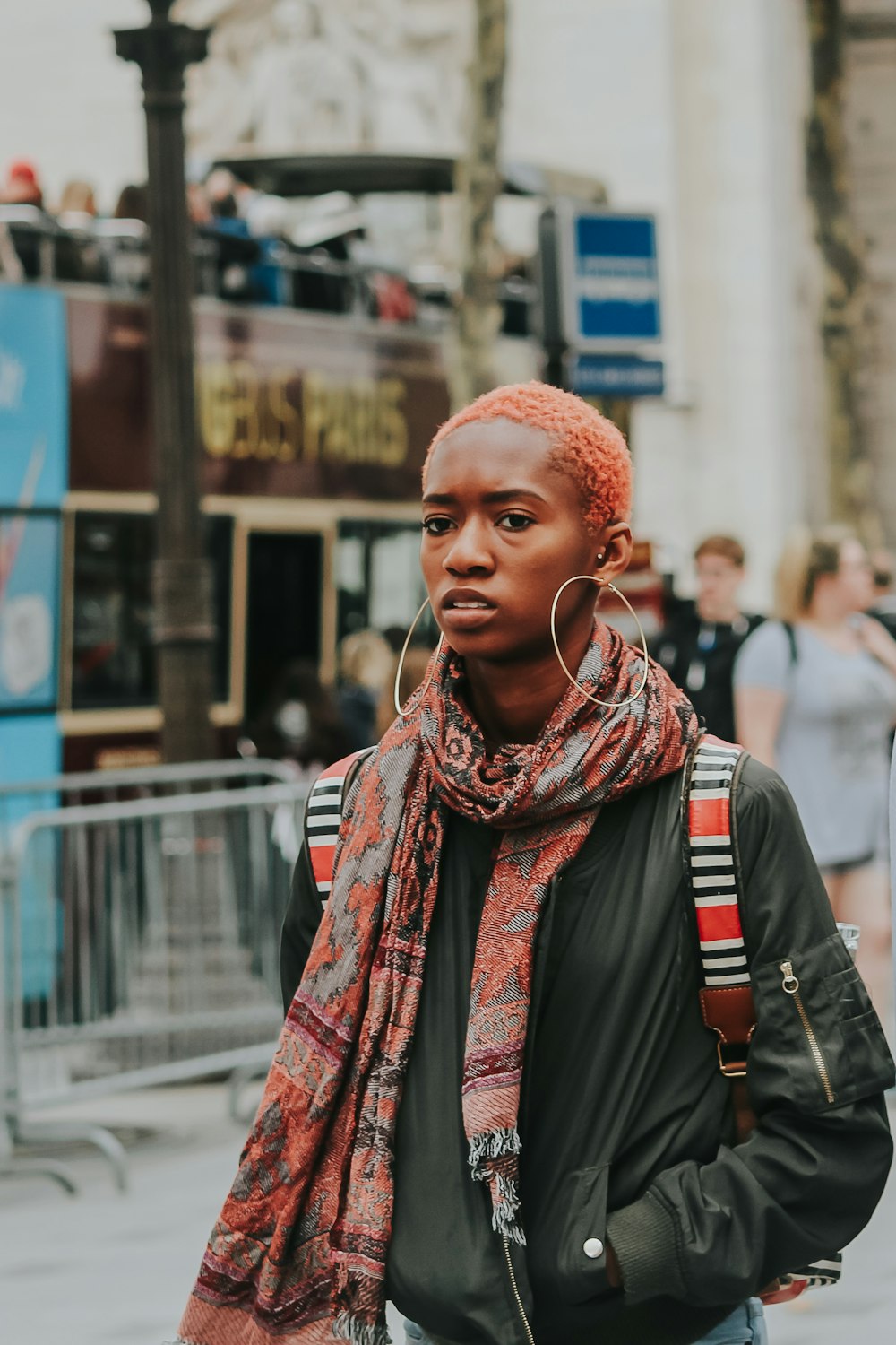 man in red and white scarf and black backpack