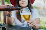 Close-up of a participant chugging a beer with determination on a sunny day