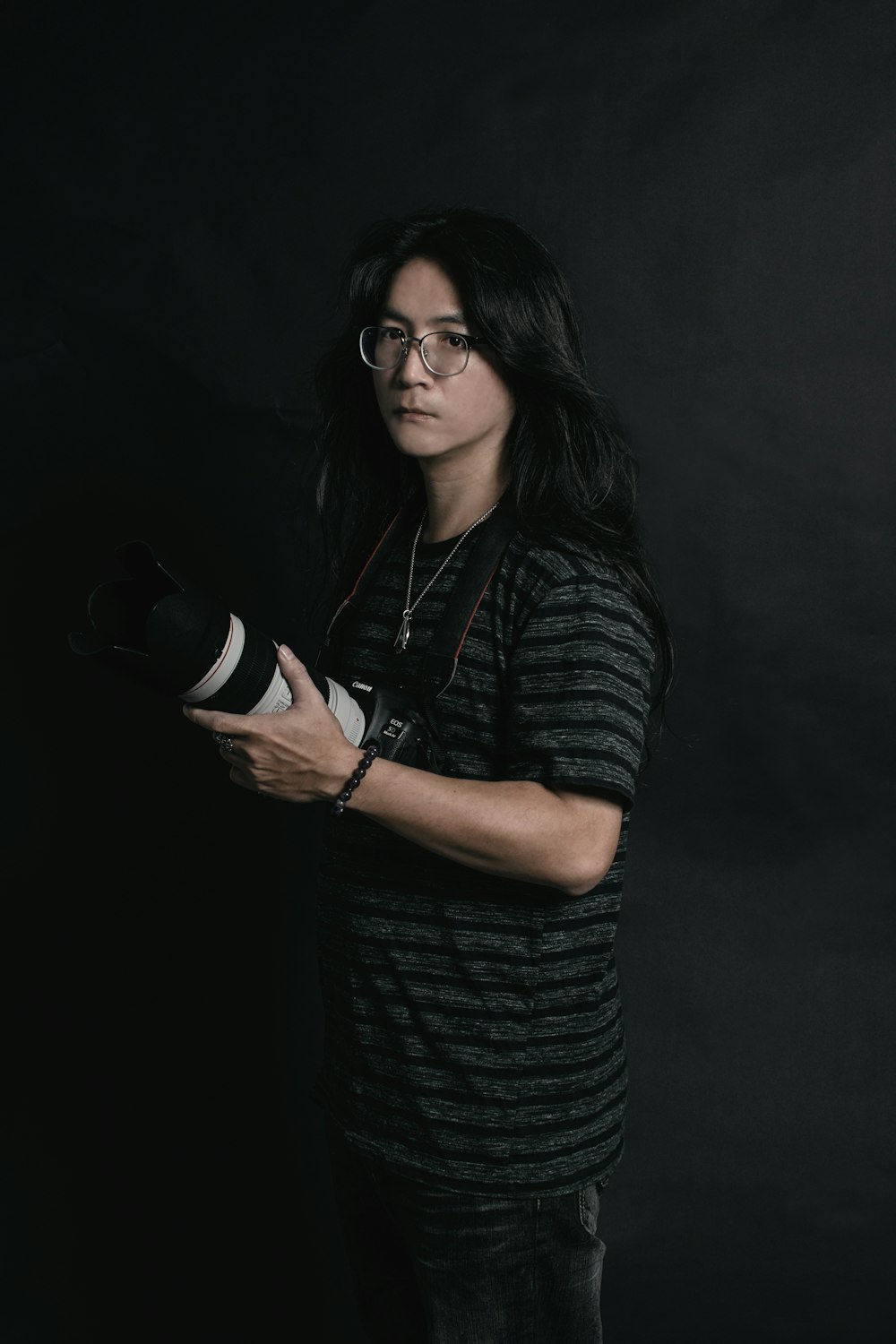 woman in black and gray stripe shirt wearing black framed eyeglasses