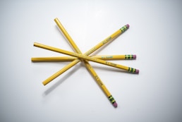 yellow and blue pencils on white surface