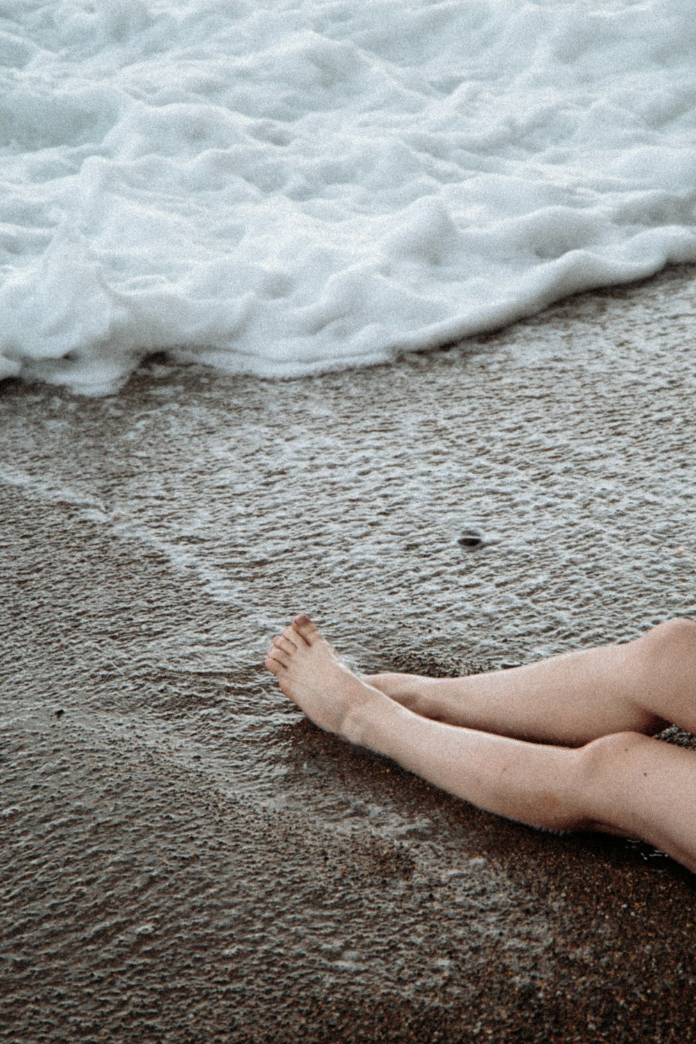 person standing on white sand during daytime