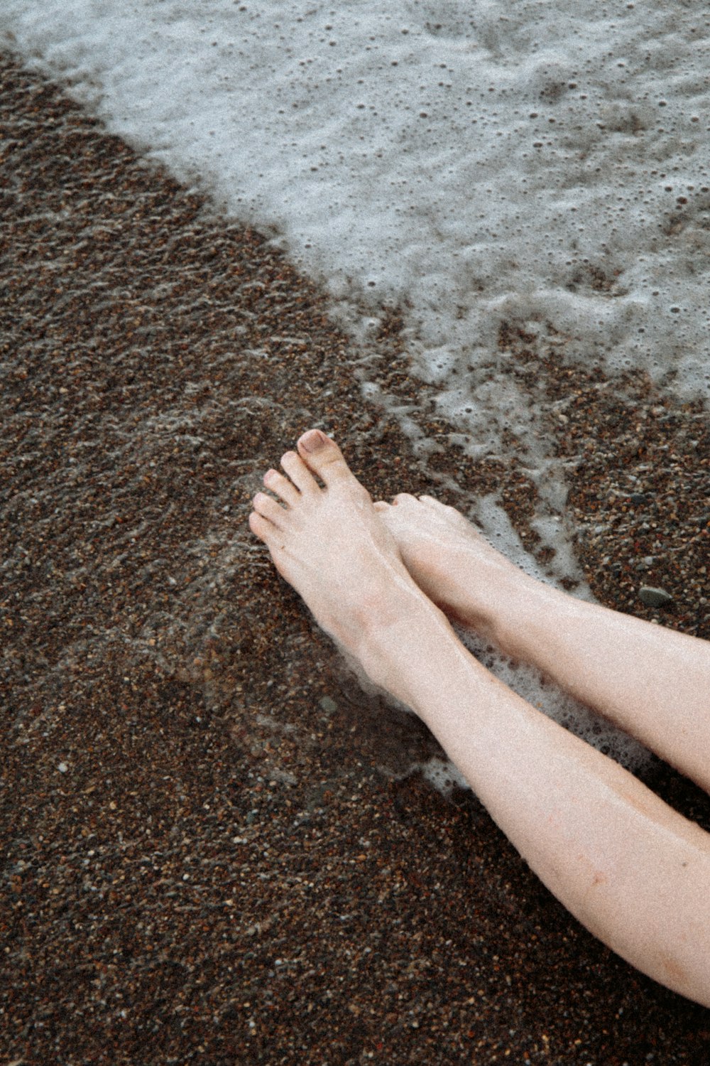 person standing on brown sand